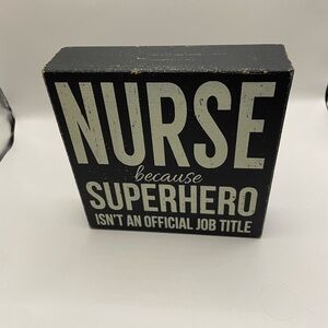 Decorative sign with 'Nurse because Superhero isn't an official job title'